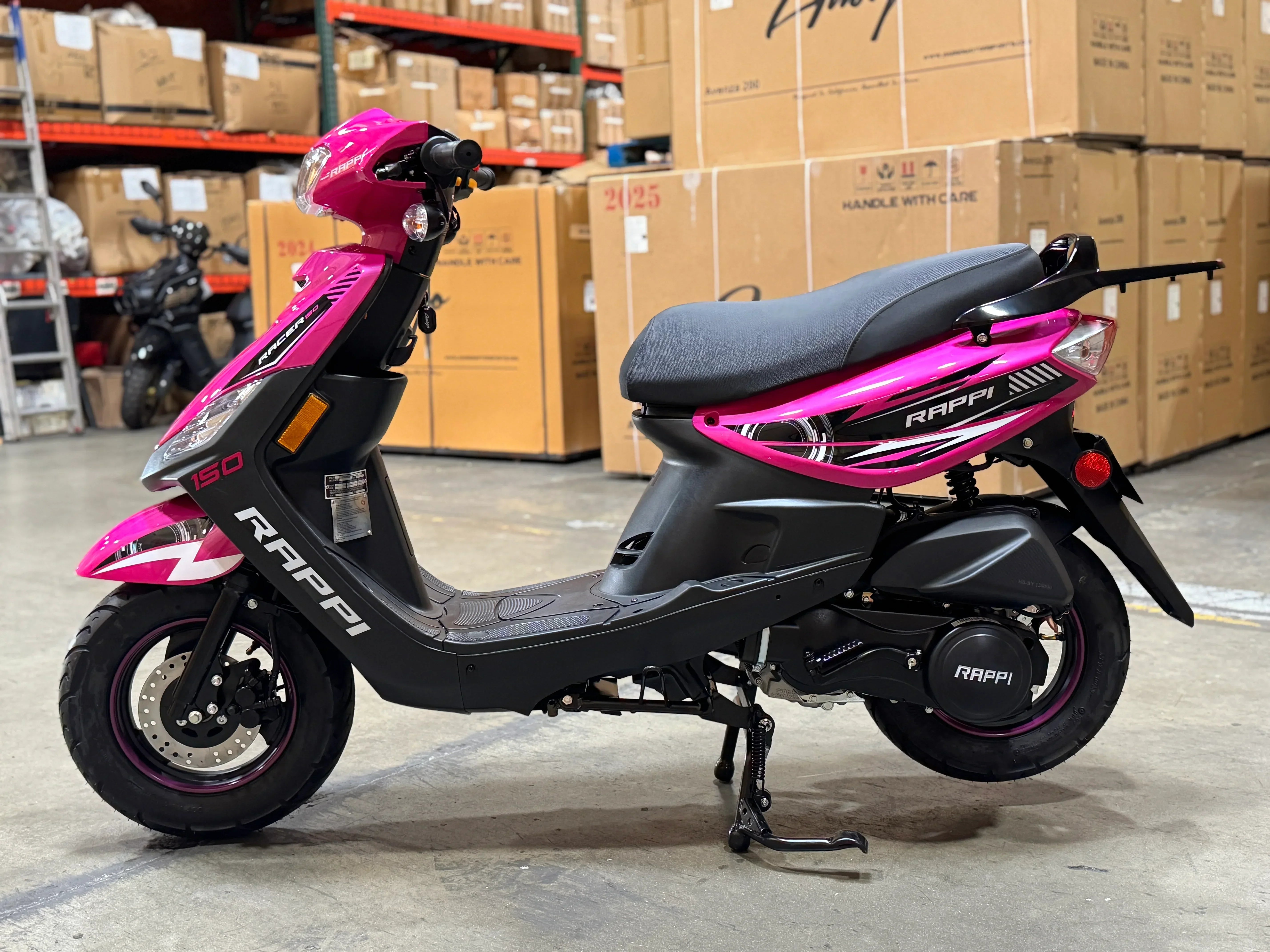 Pink and black Rappi 150cc scooter in warehouse, ideal for urban commuting and powersports enthusiasts.