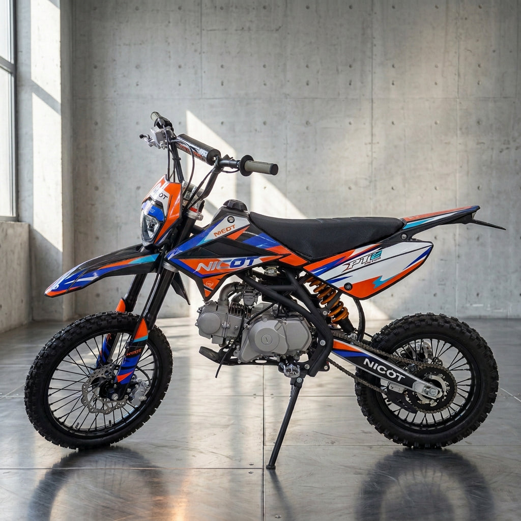 Left side profile of Nicot PT2 dirt bike showing graphics and gold shock spring