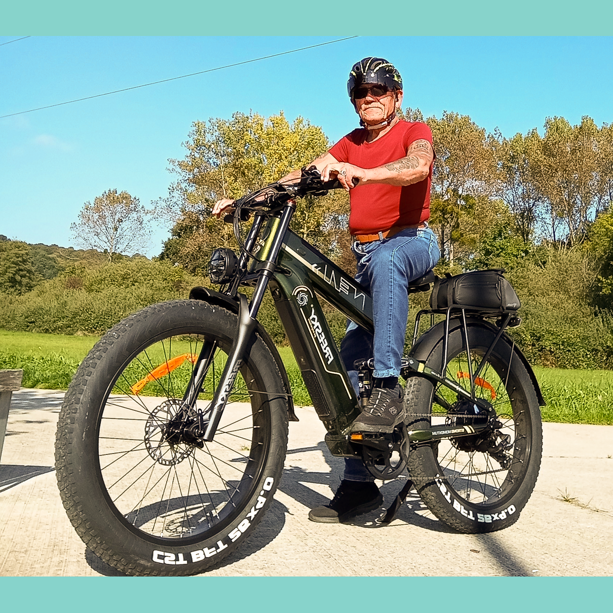 Man riding olive green Freesky Alaska e-bike on path