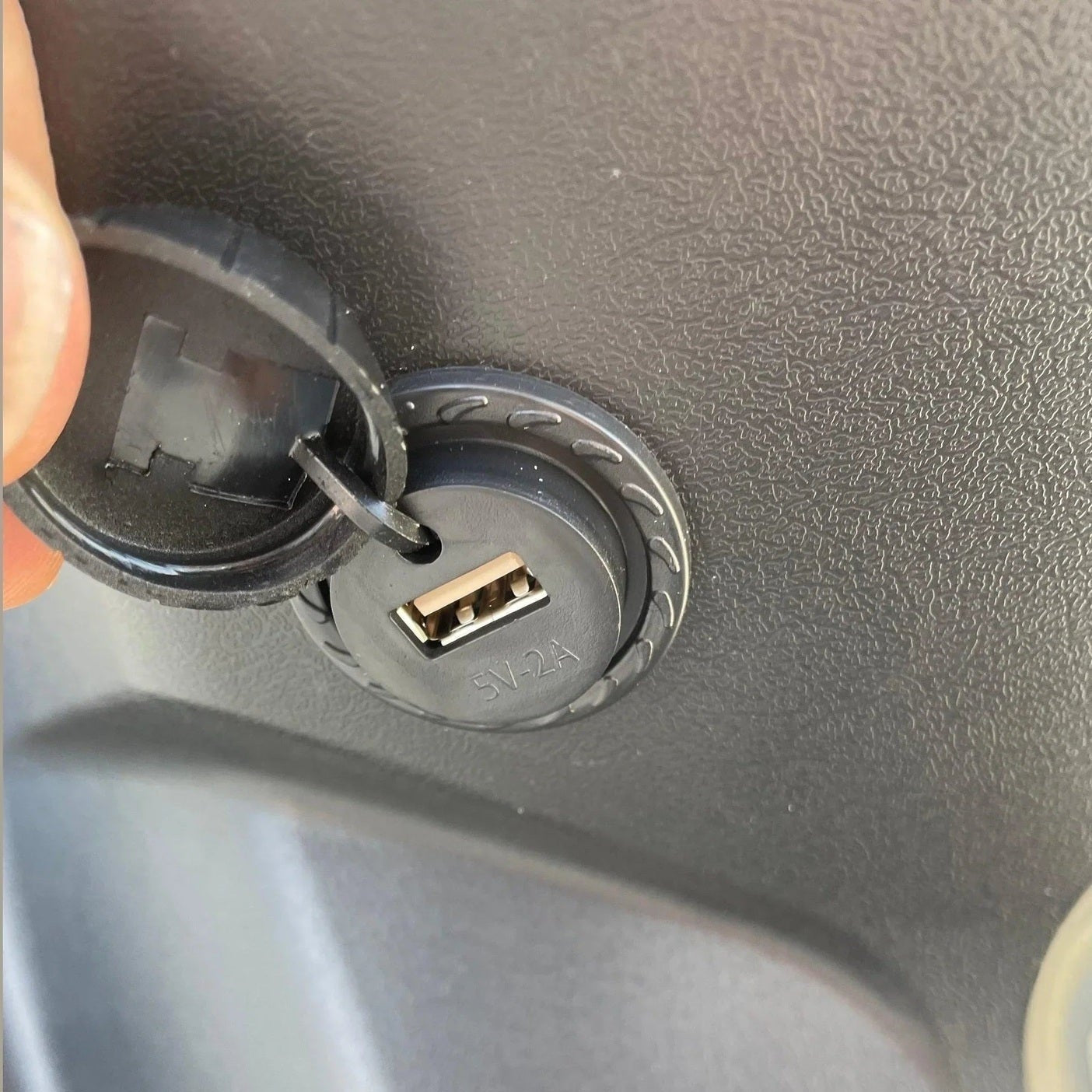 Open USB-A charging port cover on Ranger 150cc dashboard console
