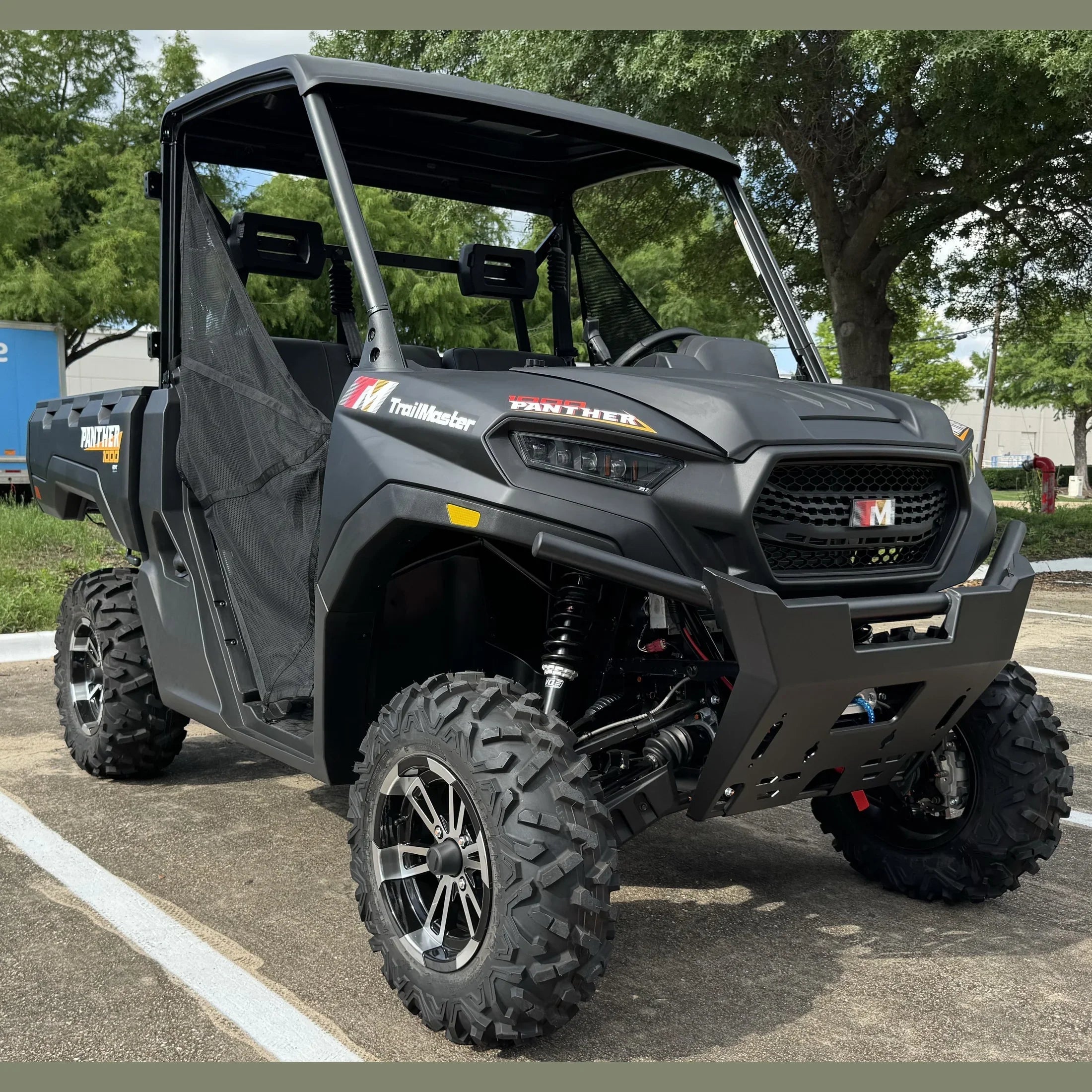 TrailMaster Panther 150 UTV with rugged tires and roll cage, parked outdoors