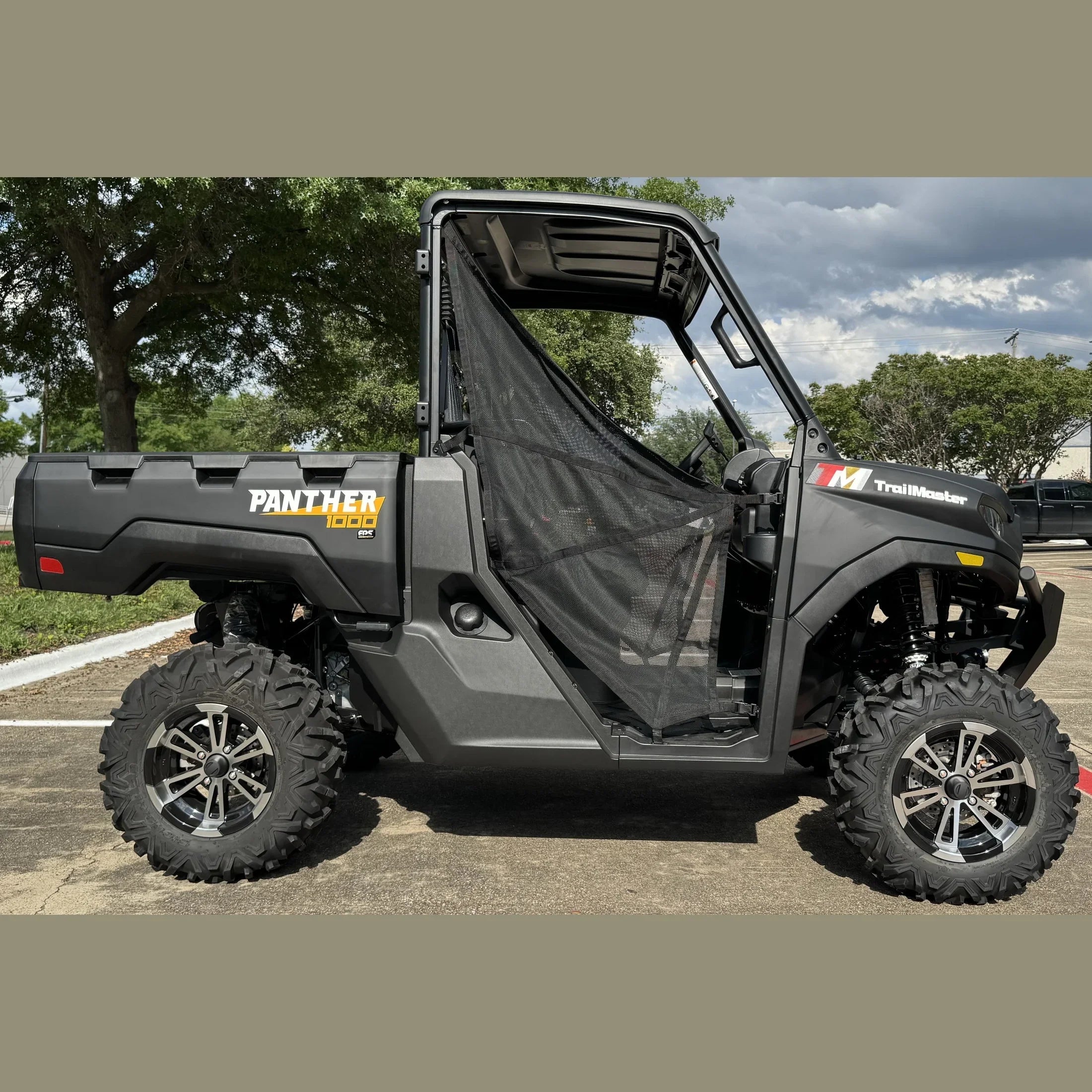 TrailMaster Panther 1000 EPS UTV with mesh door, rugged tires, parked outdoors