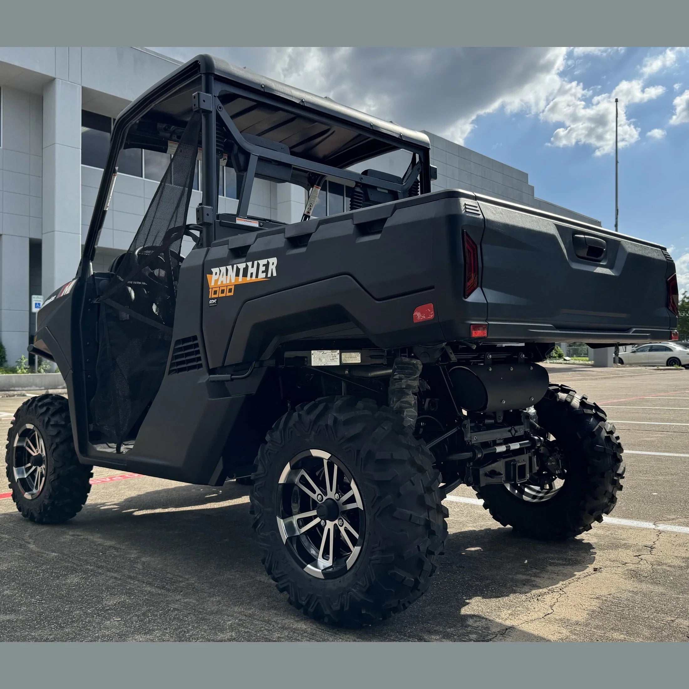 Black Panther 1000 UTV with large off-road tires parked outdoors