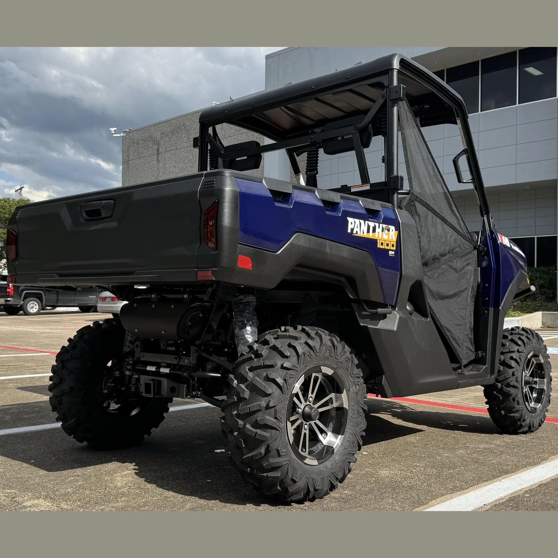 Blue Panther 1000 UTV with rugged tires parked outdoors