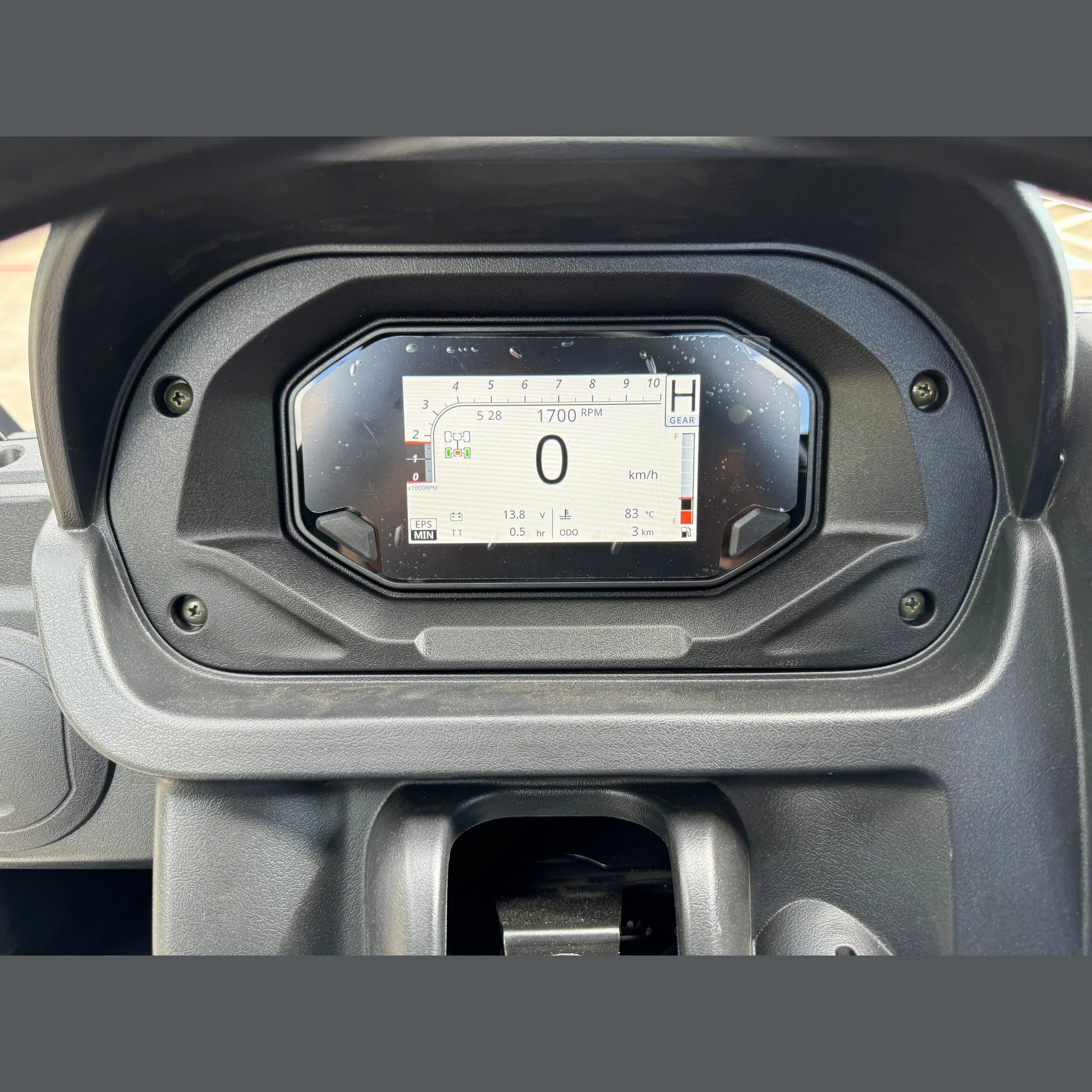 Digital dashboard display showing speed, RPM, and gear on an ATV or UTV