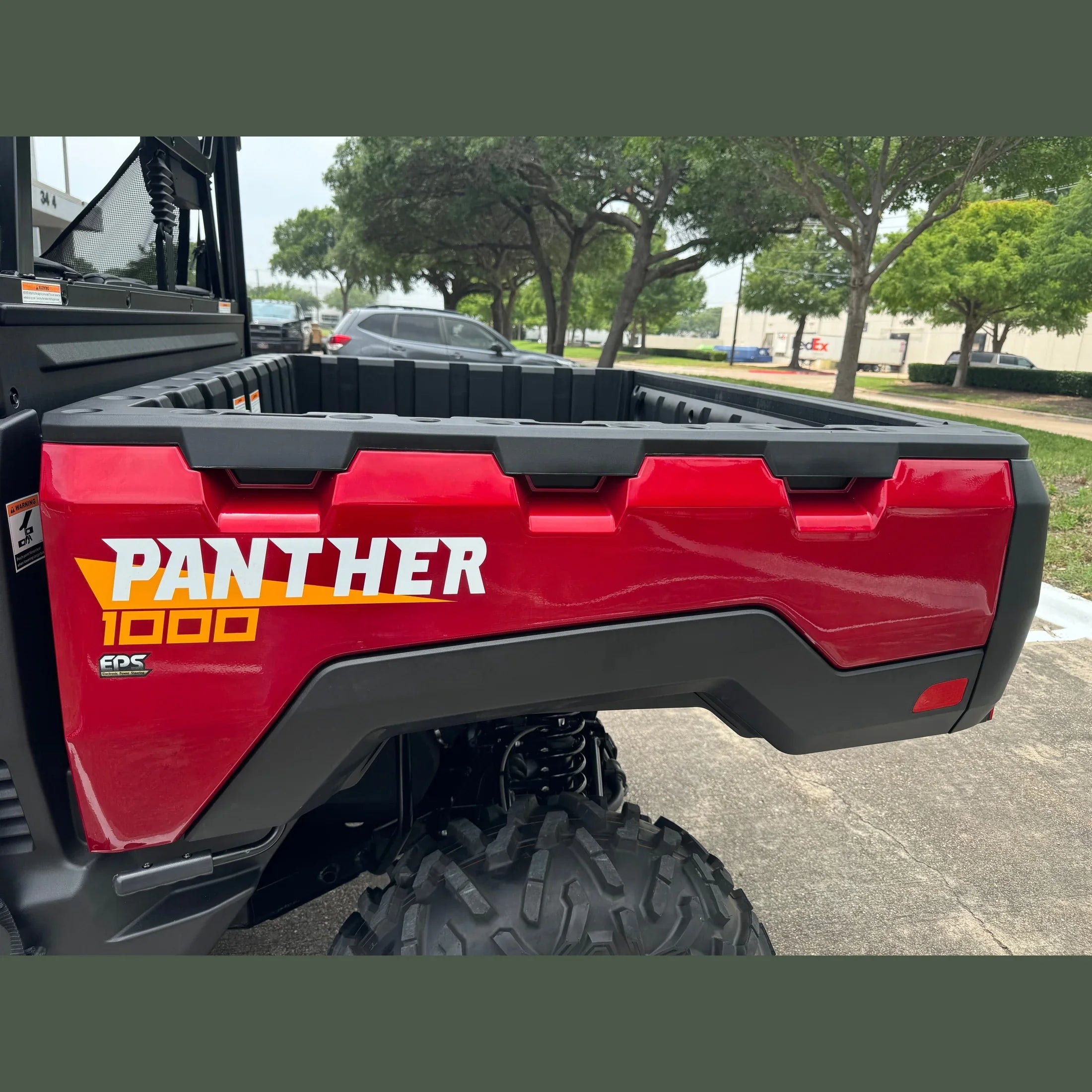 Red Panther 1000 UTV rear view with EPS, rugged tires, and cargo bed for off-road adventures