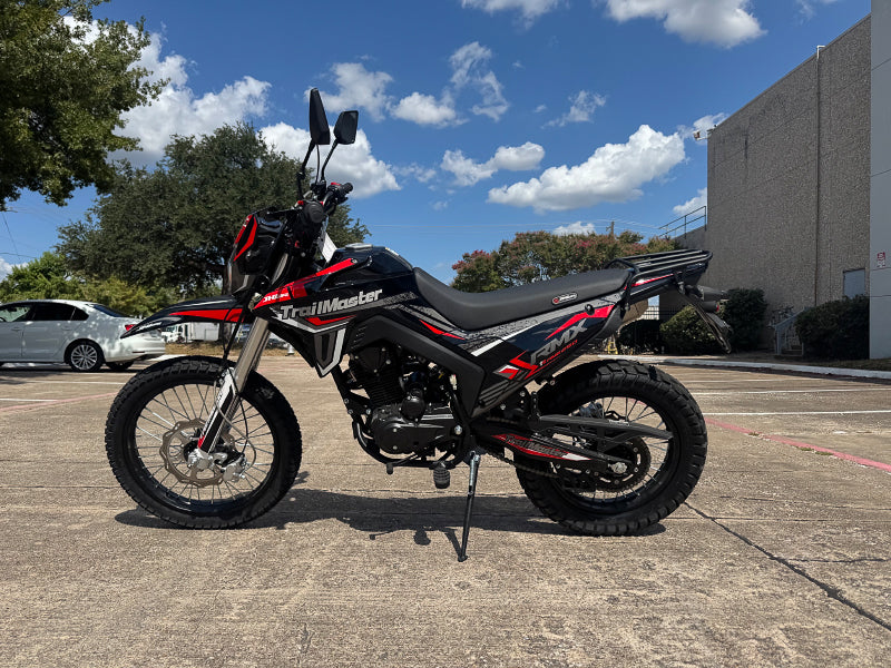 Black and red TrailMaster RMX250 dual sport dirt bike side profile with knobby tires
