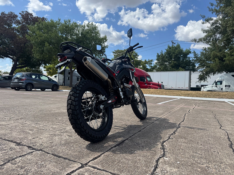 TrailMaster RMX250 dual sport dirt bike rear three-quarter view with red graphics and luggage rack