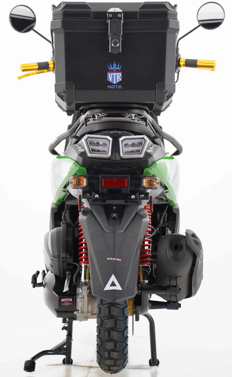 Green VTR Moto dirt bike with rear storage box, dual headlights, and red suspension springs