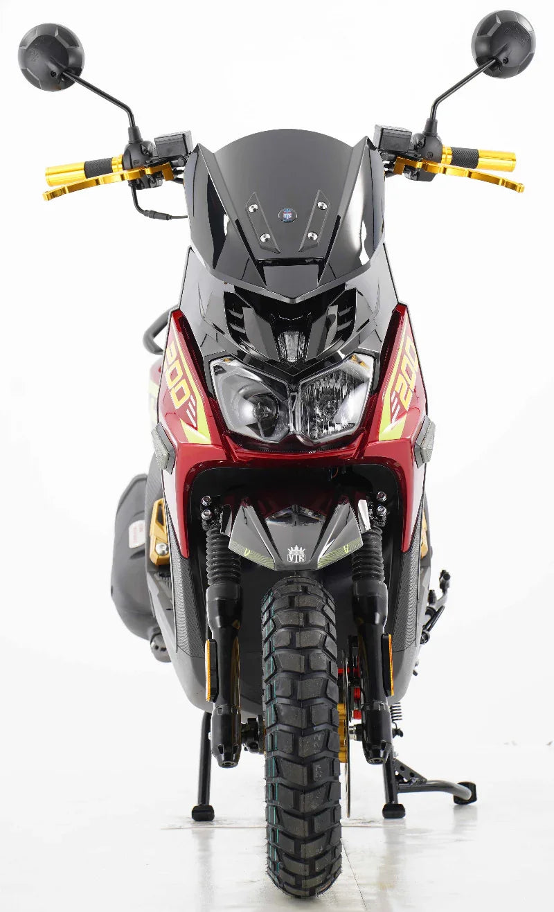Red and black dirt bike with gold handlebars, front view, off-road tires, and dual headlights