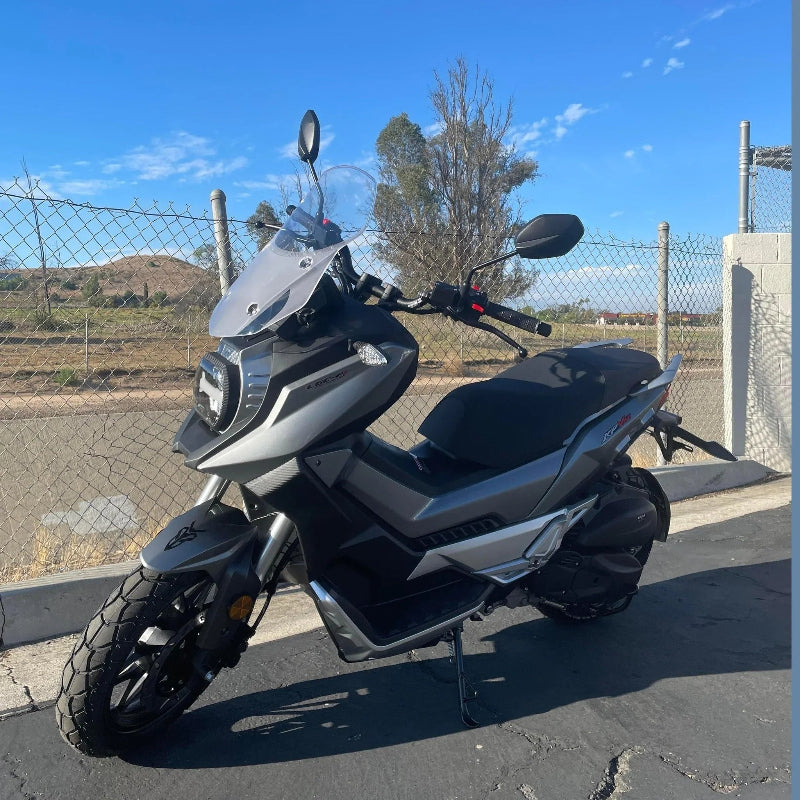 Silver Lifan KPV 150 ADV scooter with knobby tires in outdoor setting