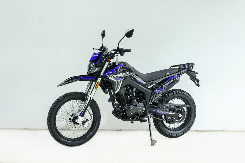 Blue and black TrailMaster RMX250 dual sport bike side profile studio shot
