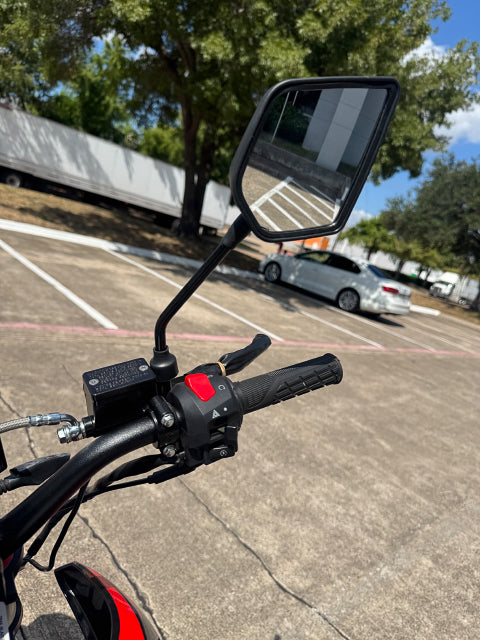 Left handlebar close-up of TrailMaster RMX250 with clutch lever and side mirror