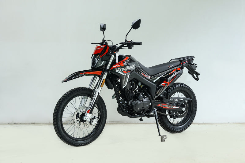 Red and black TrailMaster RMX250 dual sport motorcycle full side profile on center stand