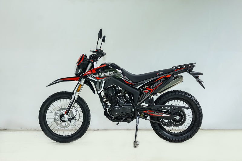 Black and red TrailMaster RMX250 full side profile with luggage rack deployed