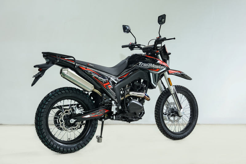 Black TrailMaster RMX250 dual sport motorcycle with red and gray graphics and knobby tires