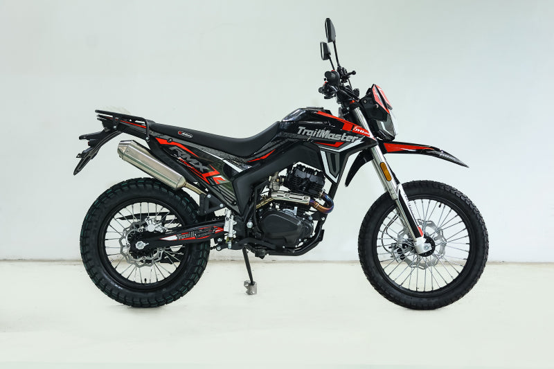 Black and gray TrailMaster RMX250 dirt bike side profile with silver exhaust and spoked wheels