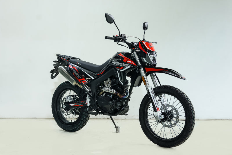 Red and black TrailMaster RMX250 enduro bike full side view with luggage rack and branding