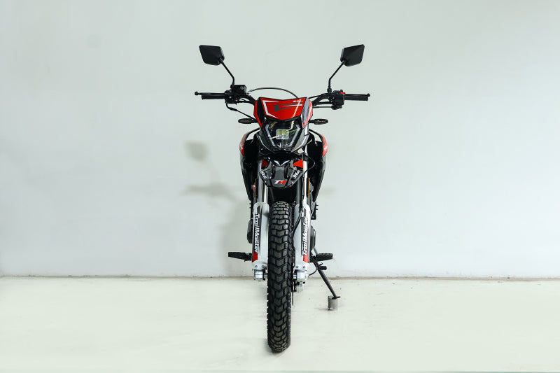Red and black TrailMaster RMX250 front view with illuminated LED headlight