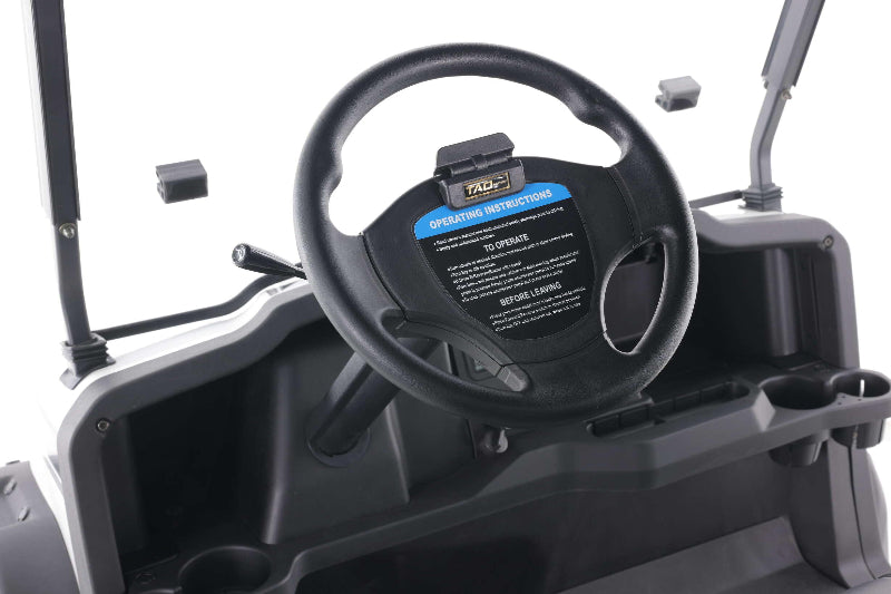Close-up of black steering wheel with operating instructions on golf cart dashboard by TAO Motor