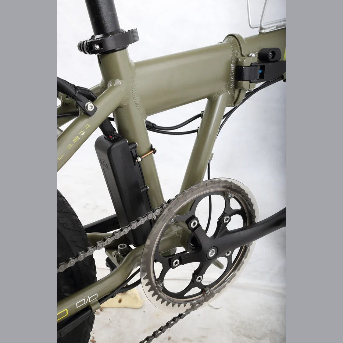 Olive green Benelli folding e-bike downtube battery pack close-up with chain drive