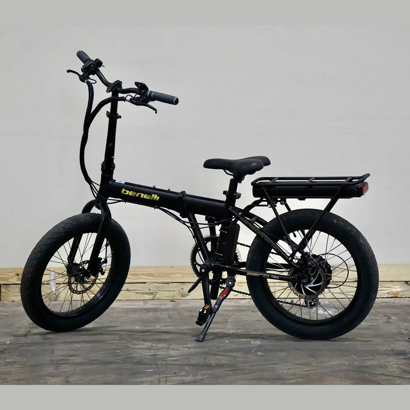 Black Benelli Zero 50 folding e-bike with thick knobby tires and cargo rack