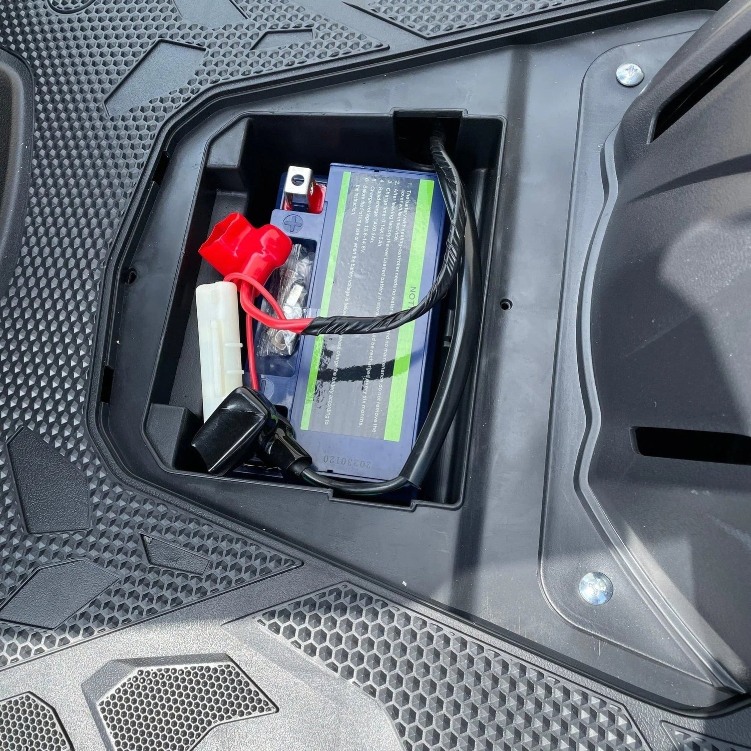Under-floorboard battery compartment with cables on Ranger 150cc