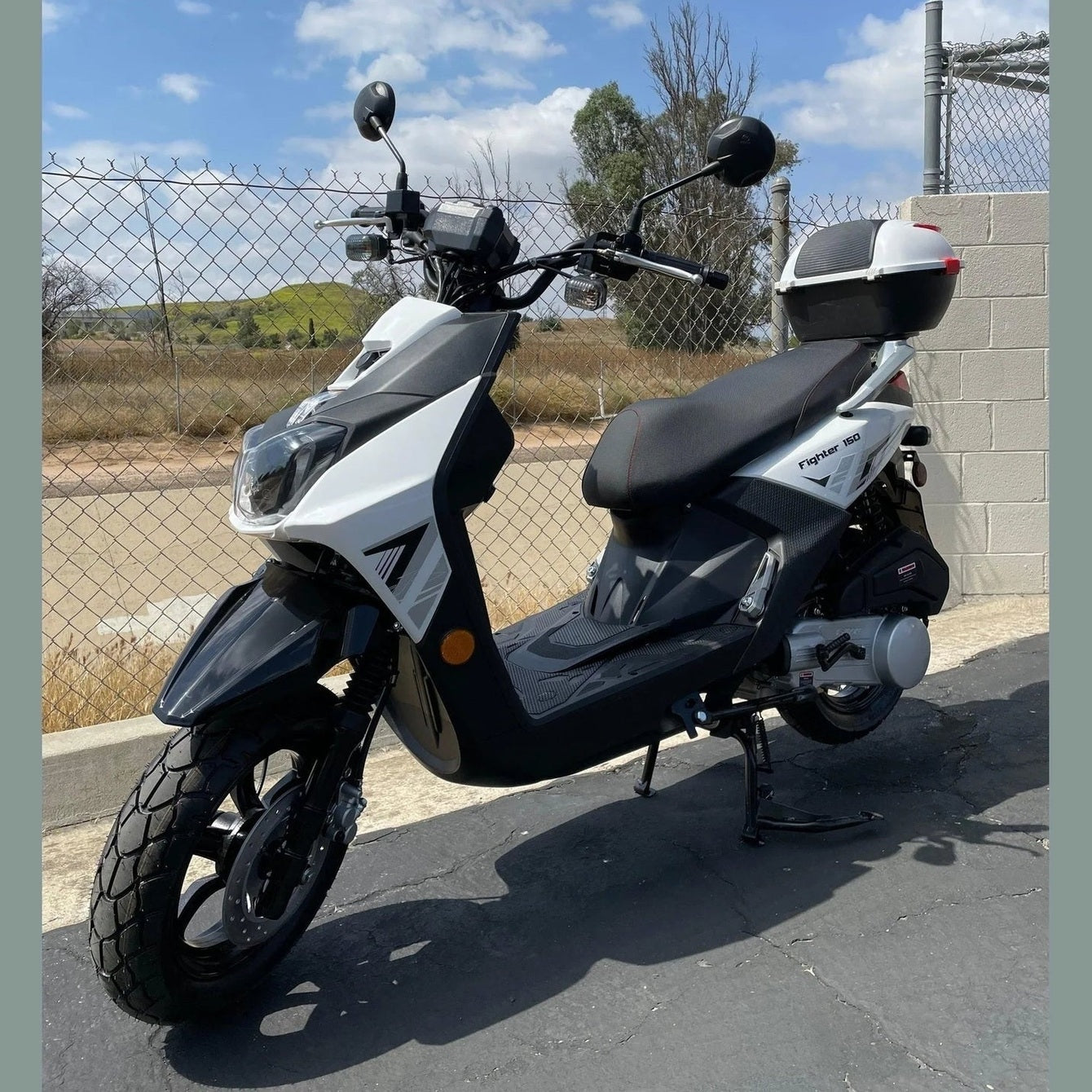 White and black Ranger 150cc scooter outdoor side profile
