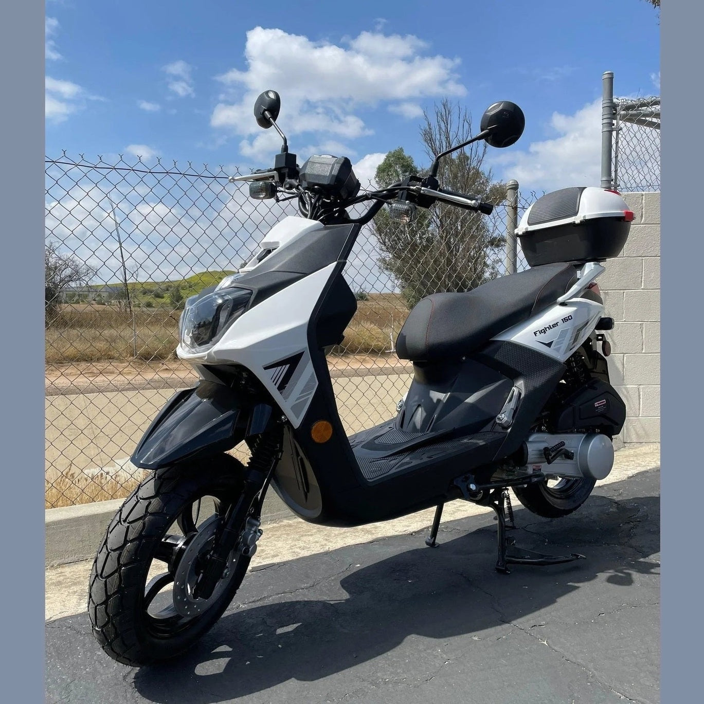 White and black Ranger 150cc scooter side profile with cargo trunk