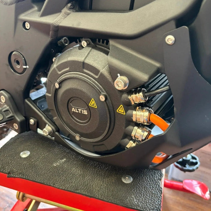close-up of black Altis hairpin motor assembly with orange high-voltage cables