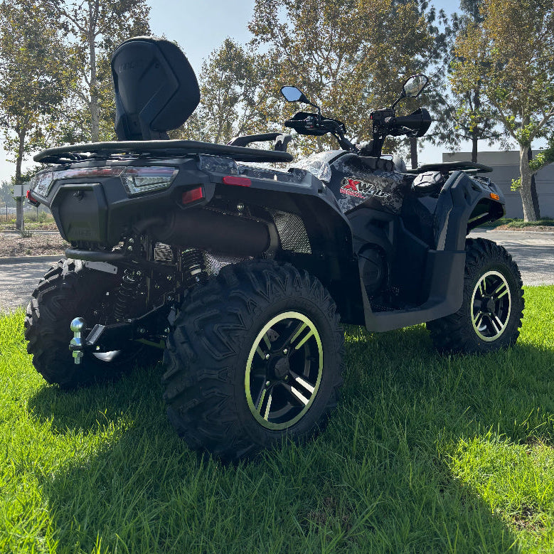 Black utility ATV with chrome winch hook and lime green wheel accents outdoors