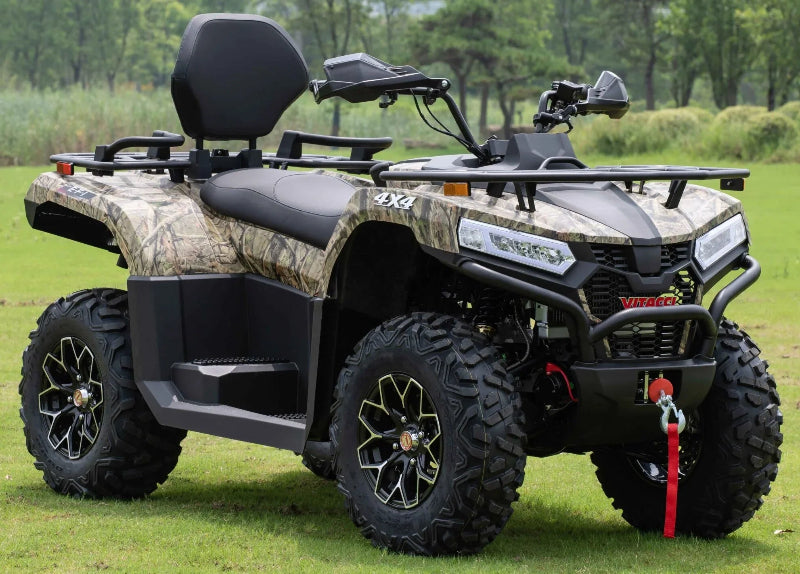 Camouflage color Vitacci 4x4 ATV with black seats and rugged tires on grass, ideal for off-road adventures and utility tasks.