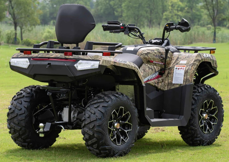 Camouflage Vitacci MAXIMUS 450L 4x4 ATV with rear cargo rack, off-road tires, and black seats on grassy field
