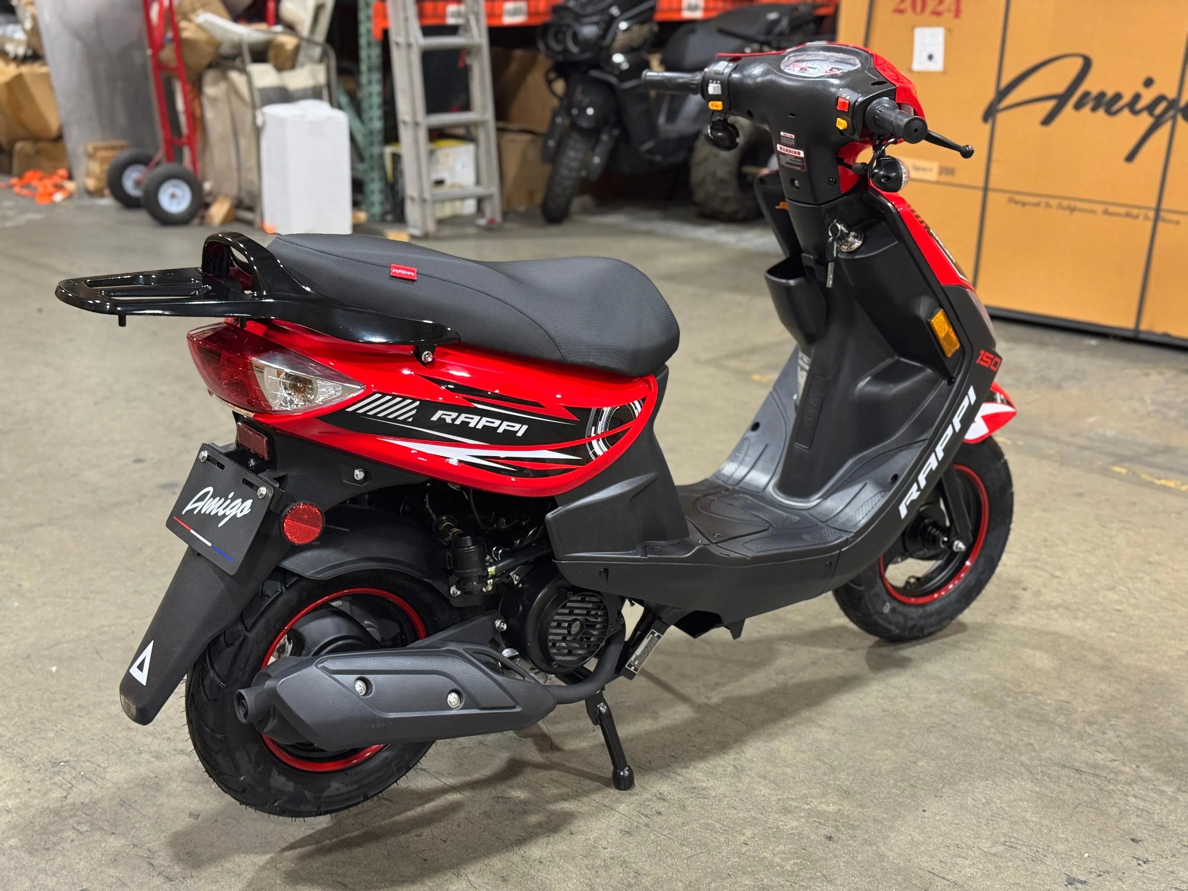 Red and black Rappi 150cc scooter in warehouse, ideal for urban commuting and powersports enthusiasts.