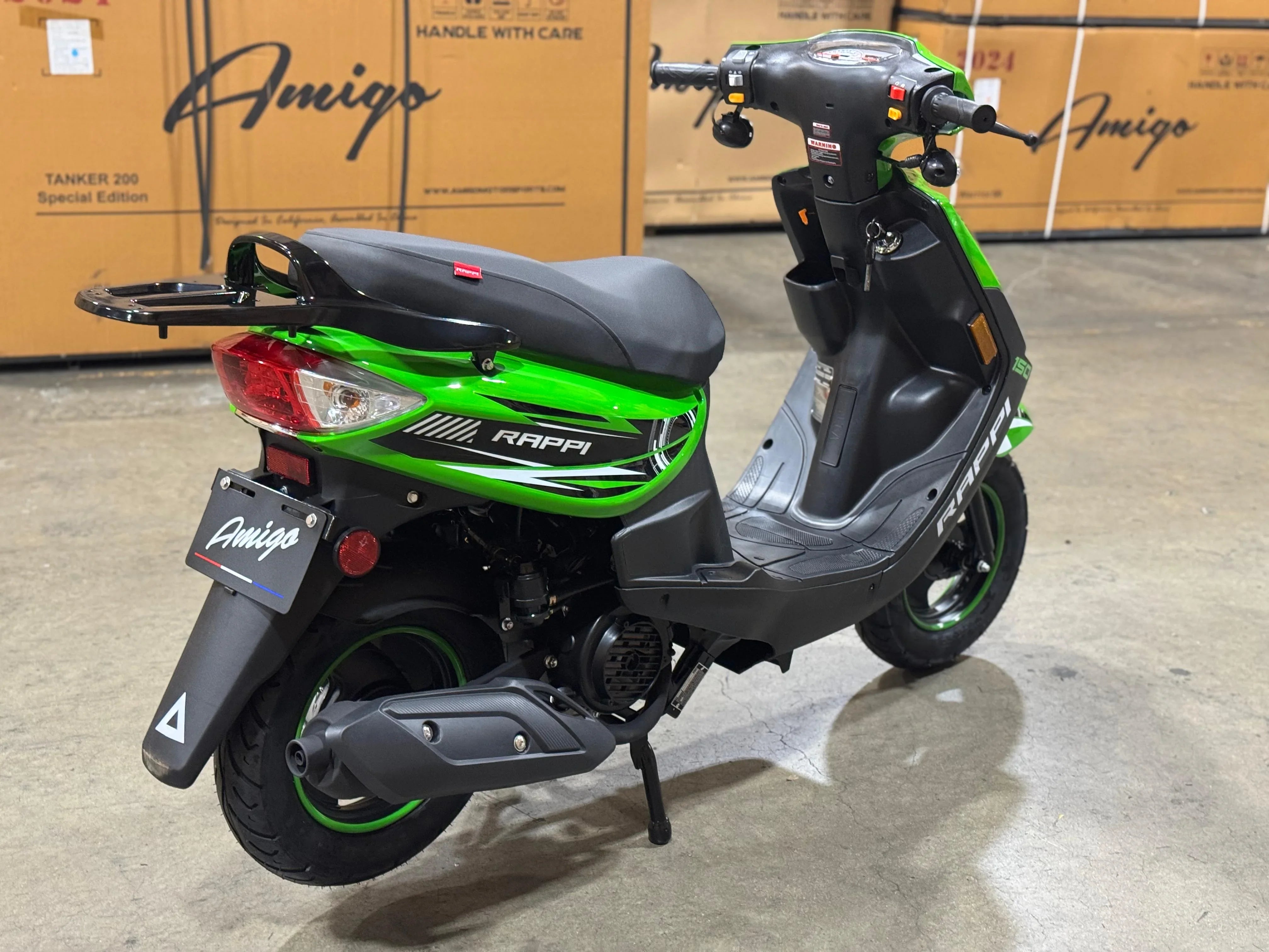 Green and black Amigo Rappi 150cc scooter in warehouse, ideal for urban commuting and powersports enthusiasts.