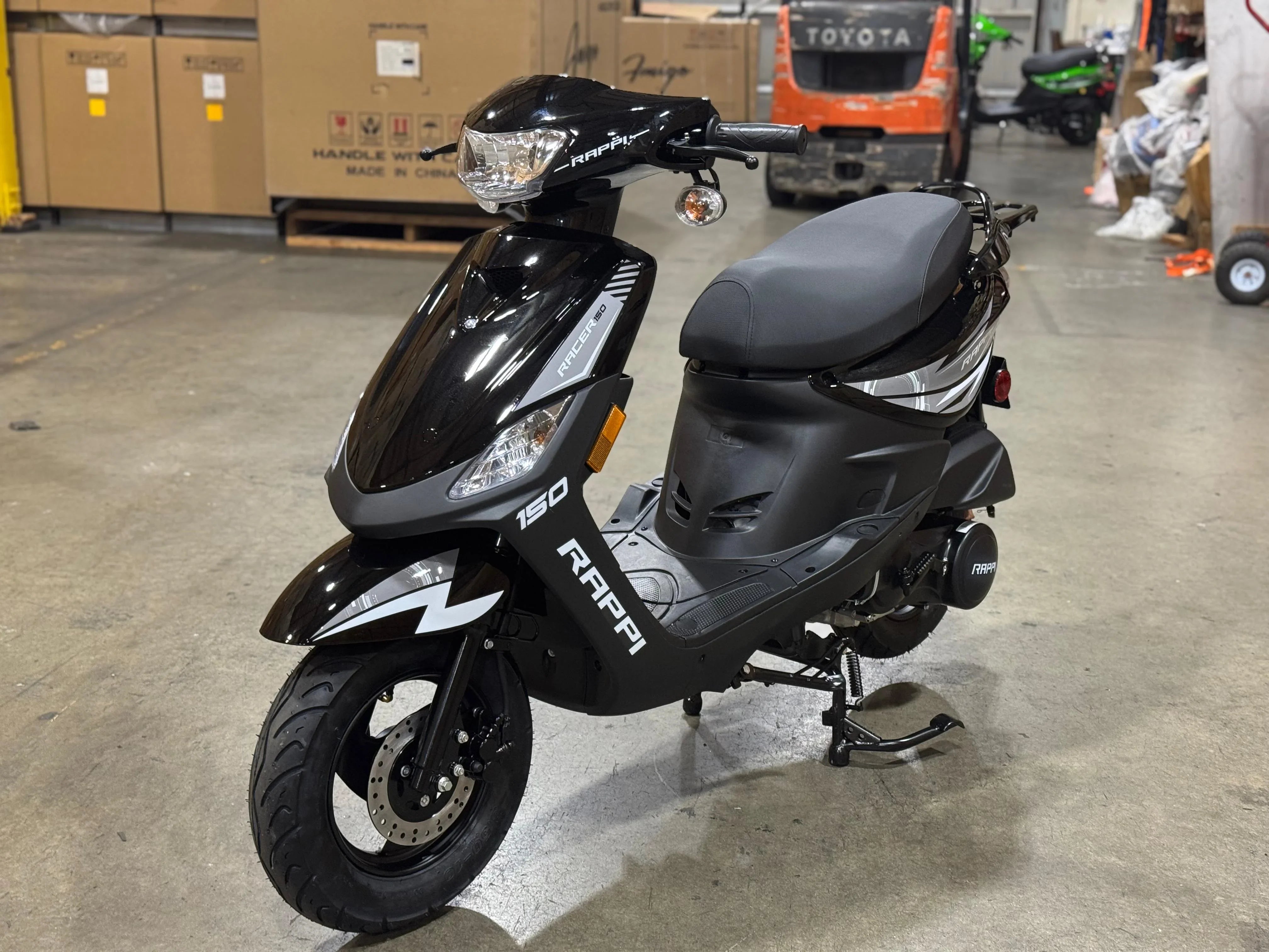 Black Rappi Racer 150 scooter in warehouse, ideal for urban commuting and powersports enthusiasts.