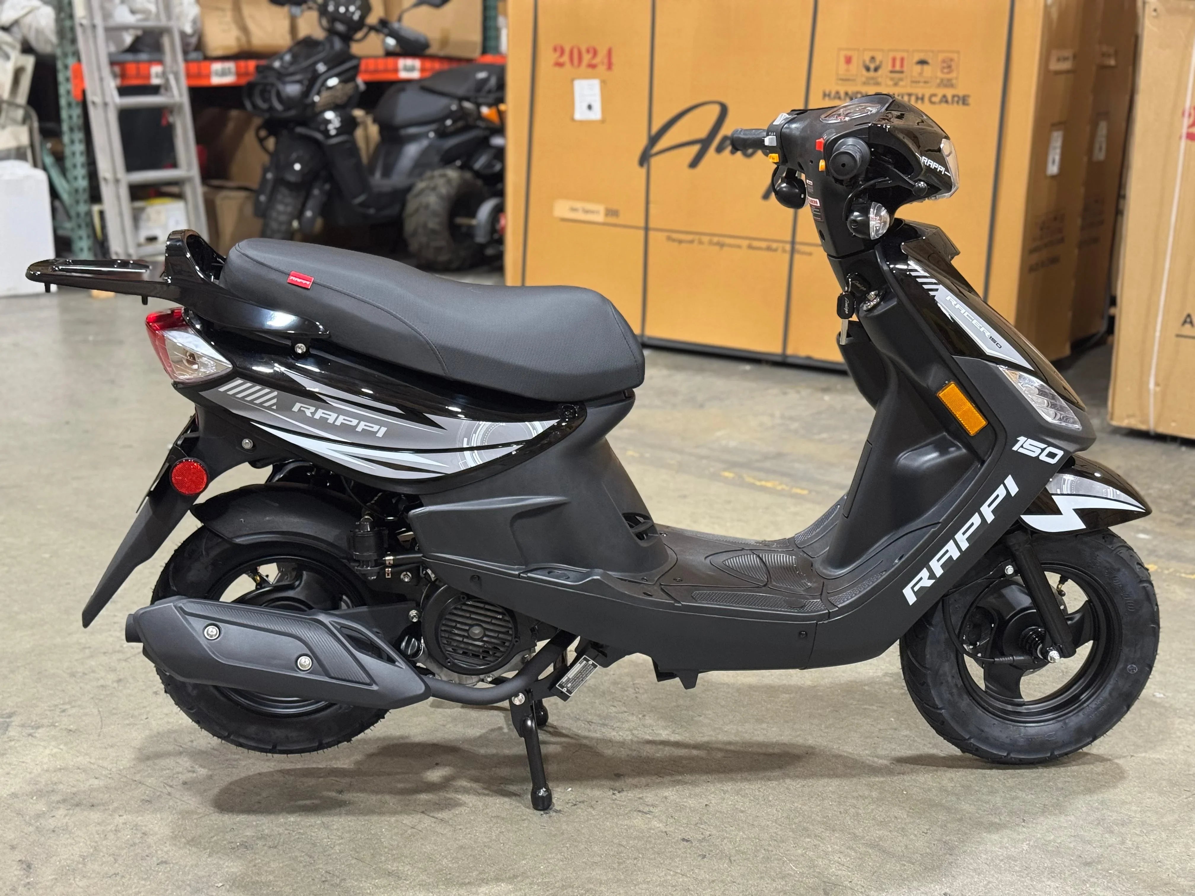 Black RAPPI 150cc scooter in warehouse, ideal for urban commuting and powersports enthusiasts.