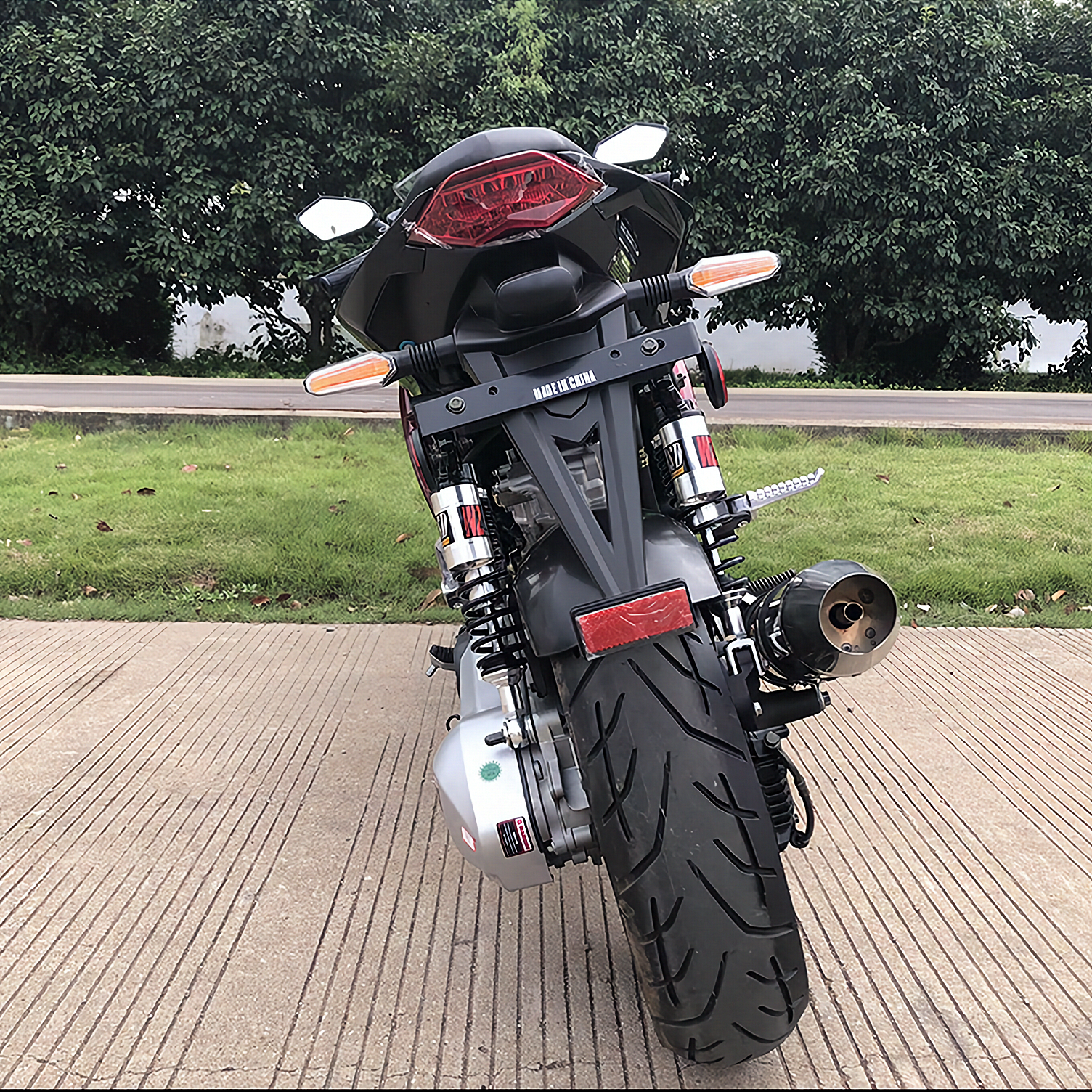 Black Apollo Falcon XR 250 EFI motorcycle rear view with chrome exhaust and disc brakes