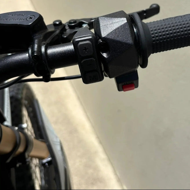 right handlebar controls of black Atlis Sigma electric dirt bike with start button
