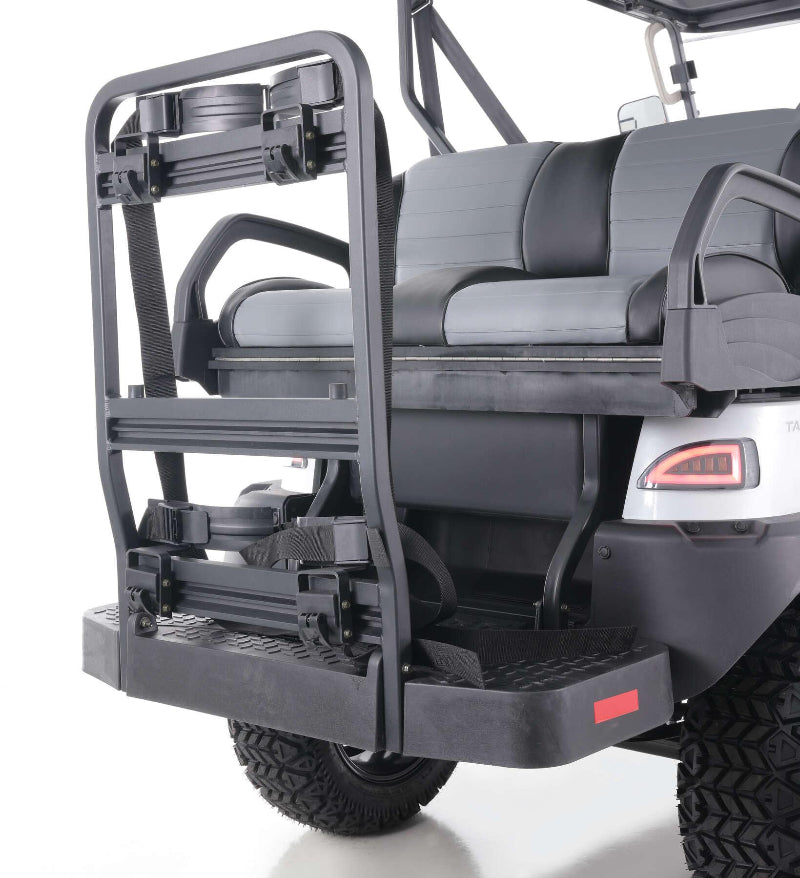 Rear seats and cargo rack on a white utility golf cart with canopy and rugged tires