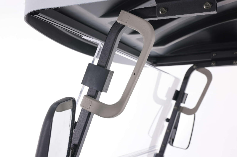 Close-up of beige grab handles and side mirrors on a UTV roof with a clear windshield