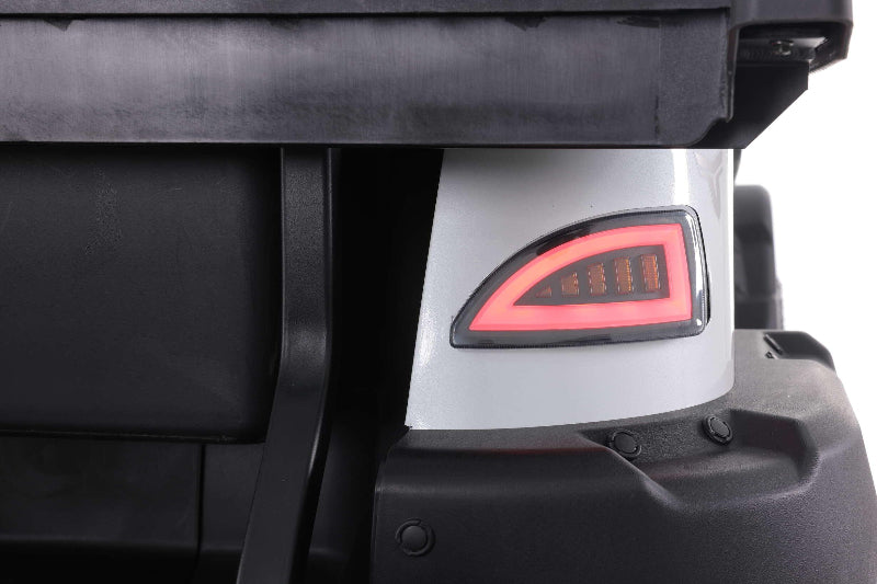 Close-up of a golf cart rear with illuminated red LED tail light and black bumper detail