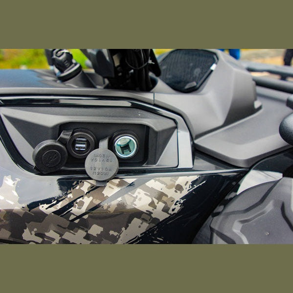 Close-up of camo Loncin XWolf 550L handlebar console with USB port and blue illuminated power outlet