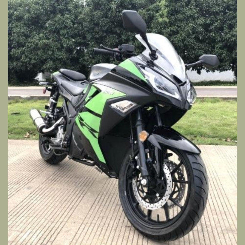 Black and green sport motorcycle outdoor shot with tall windscreen and chrome exhaust