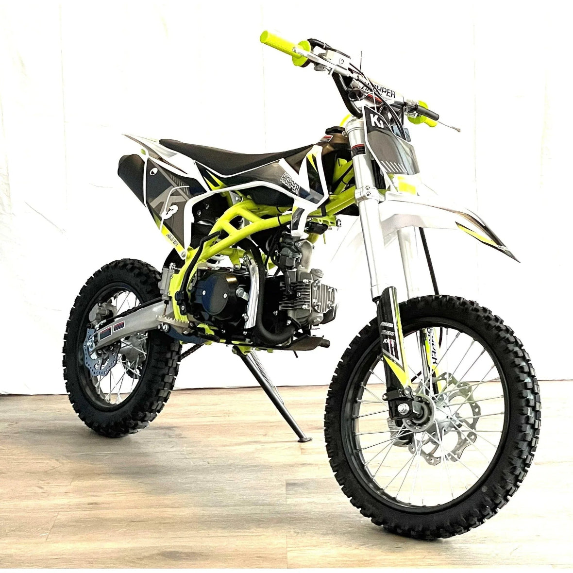 Yellow-green XTR K3 PRO 125cc dirt bike with knobby tires and telescopic front forks